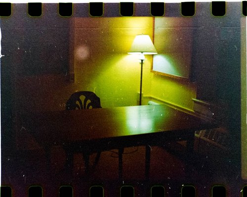 A warm desk lamp illuminating an open book in a dimly lit room